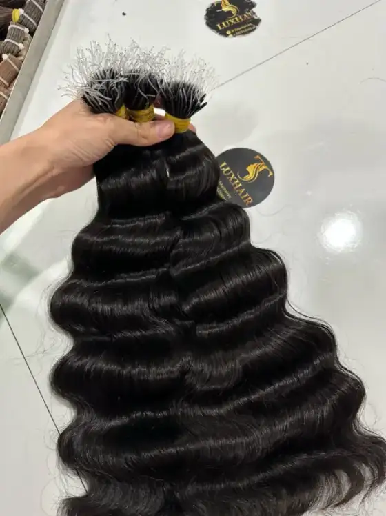 Natural black deep wave nano tip hair held in hand